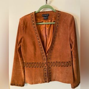 Perfect for fall. Rust colored leather jacket with rustic trim embellishments